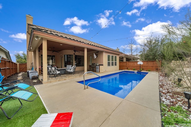 view of swimming pool with a patio and ceiling fan