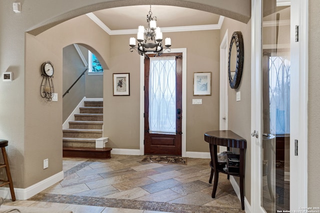 foyer entrance featuring an inviting chandelier and ornamental molding