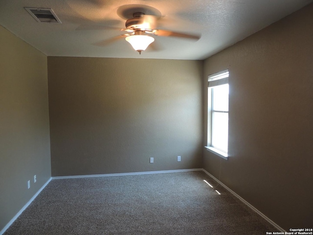 carpeted empty room with a textured ceiling and ceiling fan