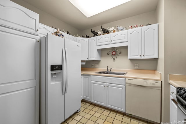 kitchen featuring white appliances, sink, and white cabinets