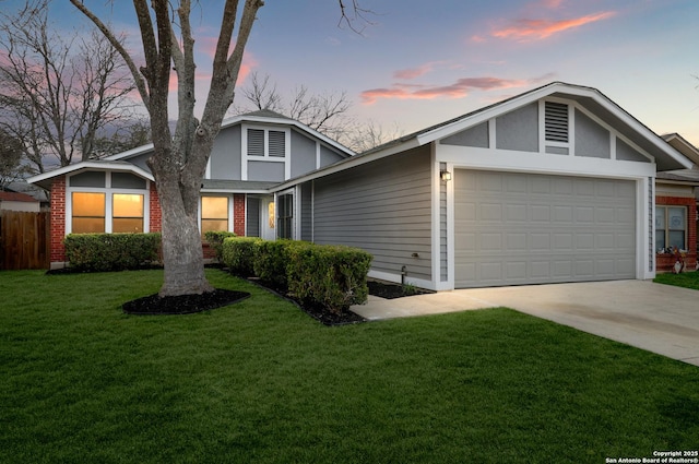 view of front of home with a garage and a yard