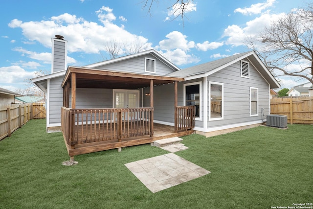 rear view of property featuring a yard, central air condition unit, and a deck