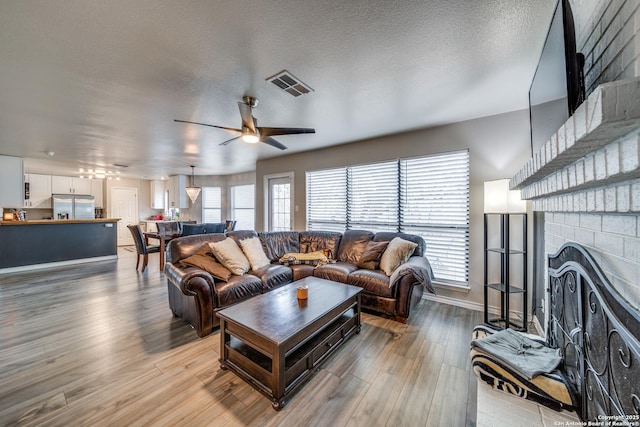 living room featuring hardwood / wood-style flooring, a healthy amount of sunlight, and a fireplace