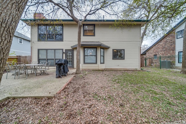 back of property with a lawn, a patio area, and central air condition unit