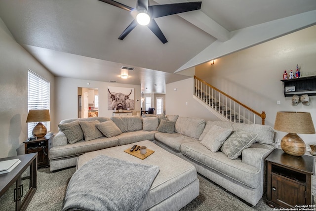 carpeted living room with lofted ceiling with beams, plenty of natural light, and ceiling fan