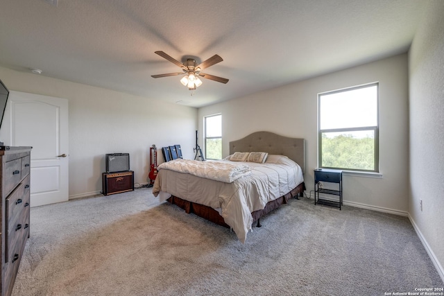 bedroom featuring ceiling fan and light carpet