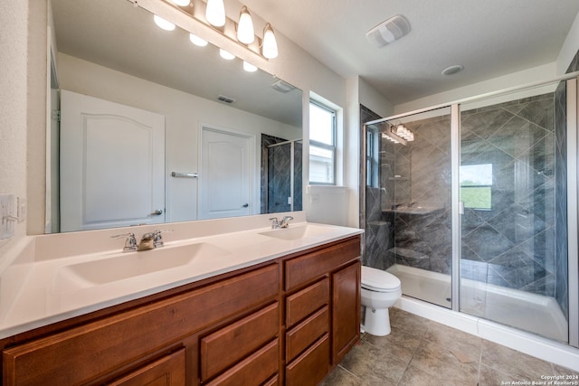 bathroom featuring vanity, an enclosed shower, and toilet