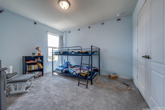 bedroom with carpet flooring and a textured ceiling