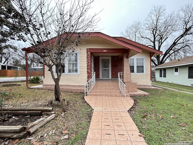 bungalow-style house with a front yard