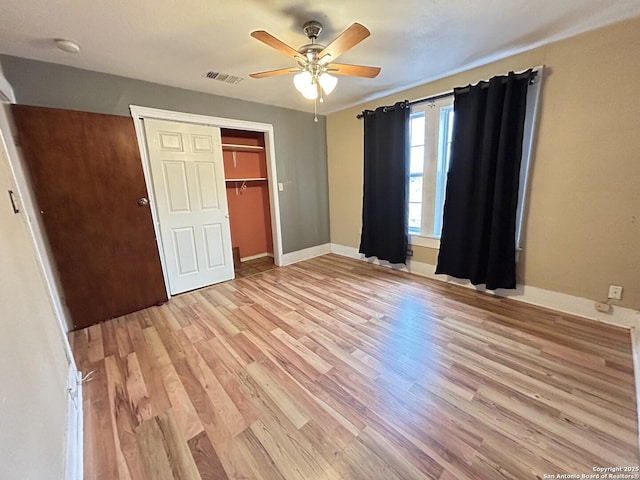 unfurnished bedroom featuring a closet, ceiling fan, and light wood-type flooring