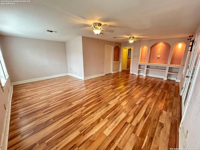 unfurnished living room featuring ceiling fan and light wood-type flooring