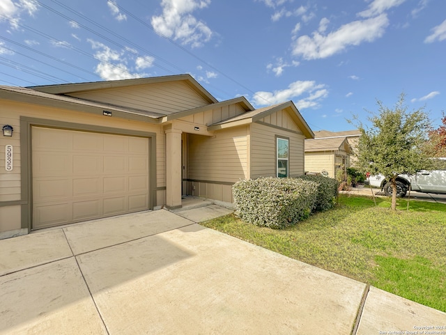 view of front of house with a garage and a front lawn