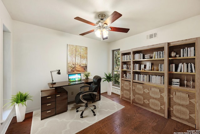 office area with dark wood-type flooring and ceiling fan