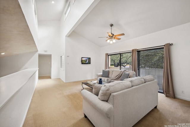 carpeted living room with high vaulted ceiling and ceiling fan