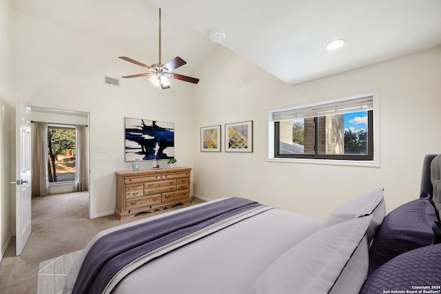 bedroom featuring ceiling fan, light colored carpet, and high vaulted ceiling