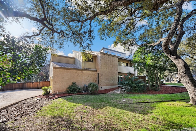 view of side of home with a lawn