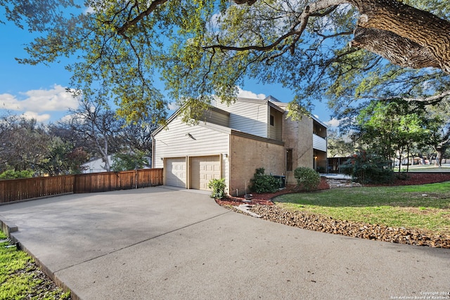 view of property exterior featuring a garage and a lawn