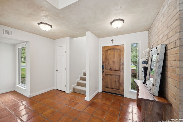 foyer with dark tile patterned flooring