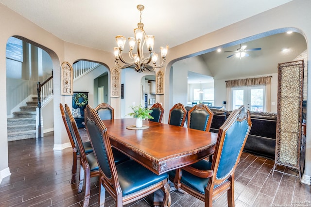 dining area featuring lofted ceiling and ceiling fan with notable chandelier