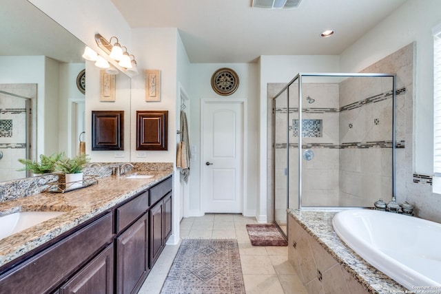 bathroom featuring tile patterned floors, independent shower and bath, and vanity