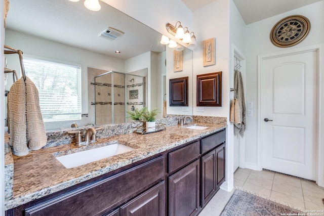 bathroom with vanity, tile patterned flooring, and walk in shower