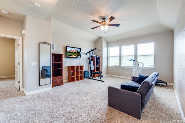 living room with lofted ceiling, a textured ceiling, light colored carpet, and ceiling fan