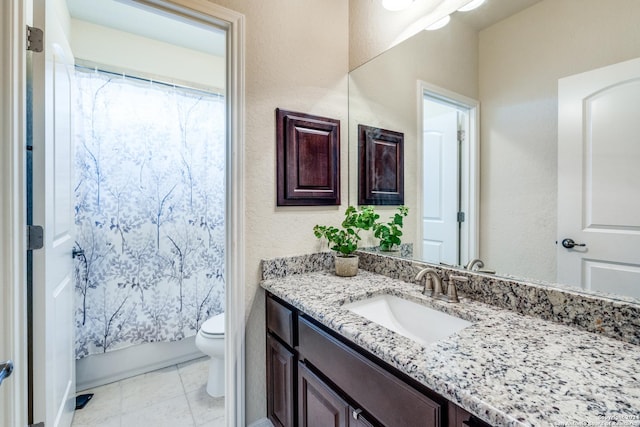 full bathroom with tile patterned floors, vanity, toilet, and shower / bath combo with shower curtain