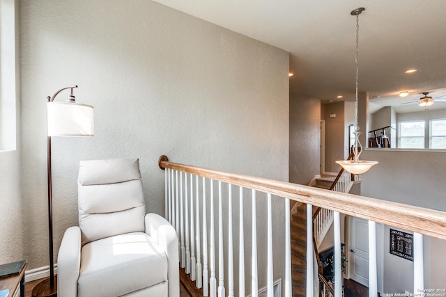 sitting room featuring ceiling fan