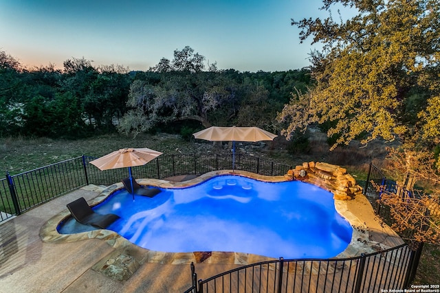 view of pool at dusk