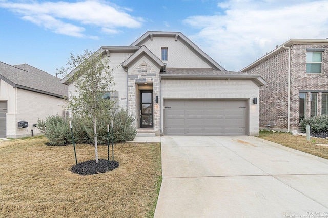 view of front of house with a garage and a front yard