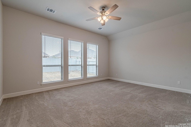 carpeted spare room featuring ceiling fan and lofted ceiling