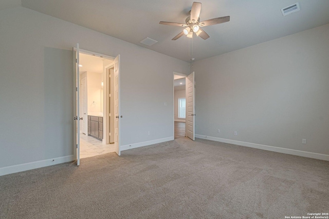 empty room featuring ceiling fan and light colored carpet