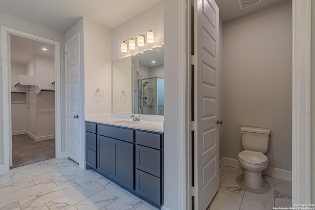 bathroom featuring an enclosed shower, vanity, and toilet