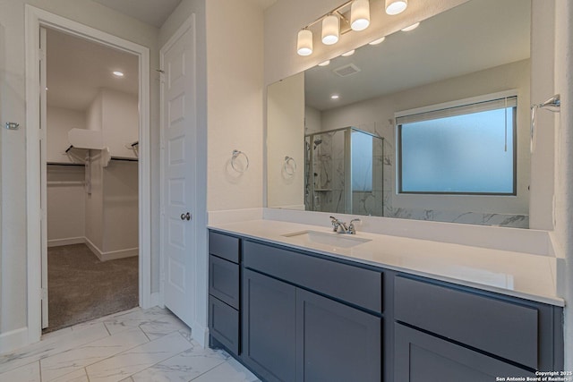 bathroom with walk in shower and vanity