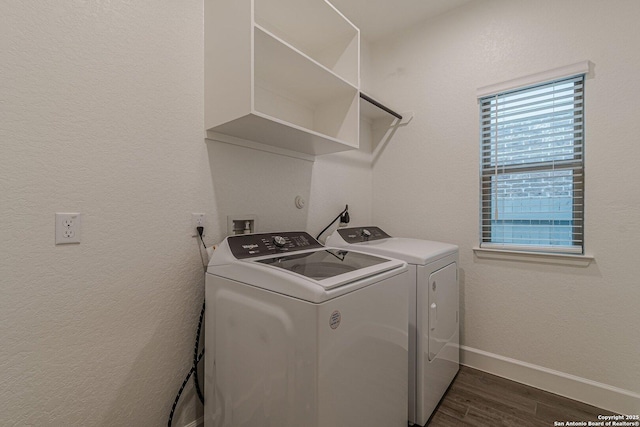 laundry room with dark hardwood / wood-style flooring and washing machine and dryer