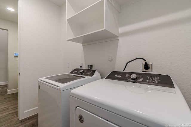 washroom with dark hardwood / wood-style floors and washer and dryer