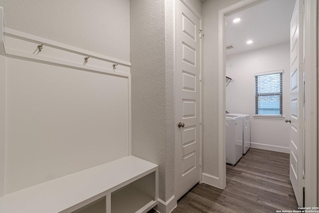 mudroom featuring dark wood-type flooring and independent washer and dryer