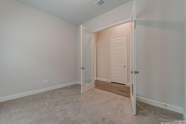 unfurnished bedroom with light colored carpet