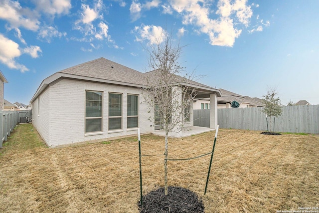 back of property featuring a yard and a patio