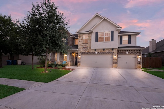 view of front facade featuring a garage and a lawn