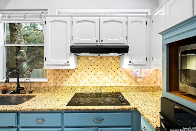 kitchen featuring blue cabinetry, white cabinets, sink, and black appliances