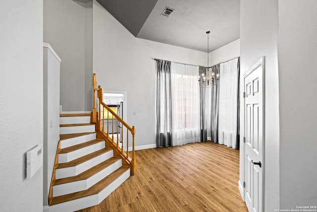 foyer featuring a chandelier and light hardwood / wood-style flooring