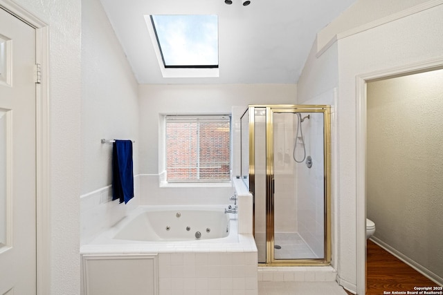 bathroom with wood-type flooring, lofted ceiling with skylight, plus walk in shower, and toilet