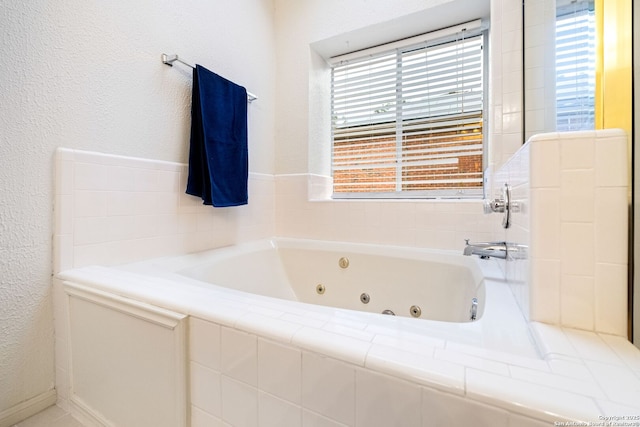 bathroom featuring a relaxing tiled tub