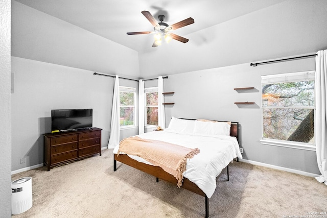 bedroom featuring vaulted ceiling, light colored carpet, and ceiling fan