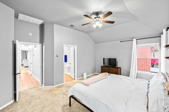 bedroom featuring lofted ceiling, light carpet, ceiling fan, and ensuite bathroom