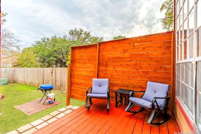 deck with a patio and a lawn