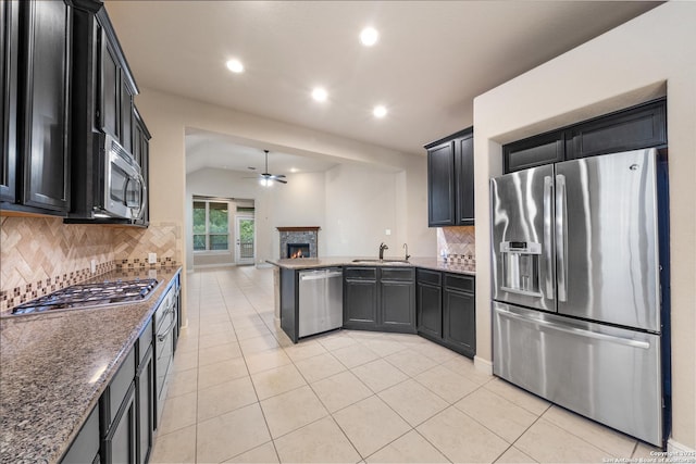 kitchen with appliances with stainless steel finishes, sink, light tile patterned floors, and ceiling fan