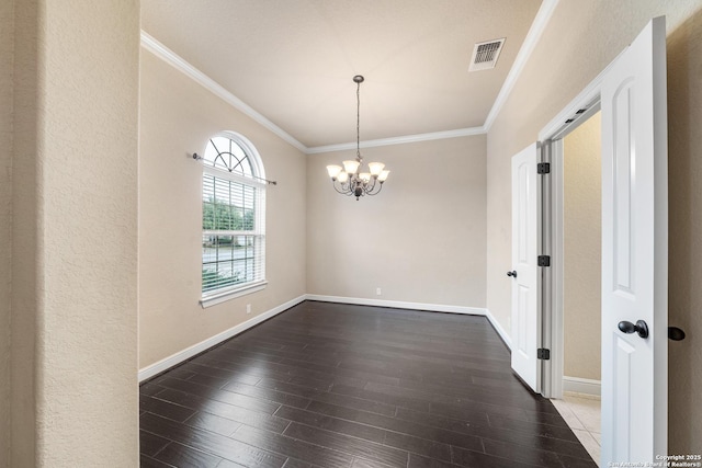 empty room featuring crown molding, an inviting chandelier, and dark hardwood / wood-style flooring