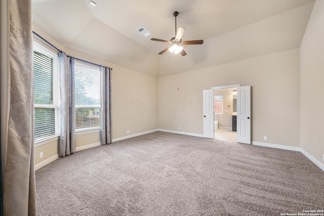 spare room with ceiling fan, carpet flooring, and vaulted ceiling